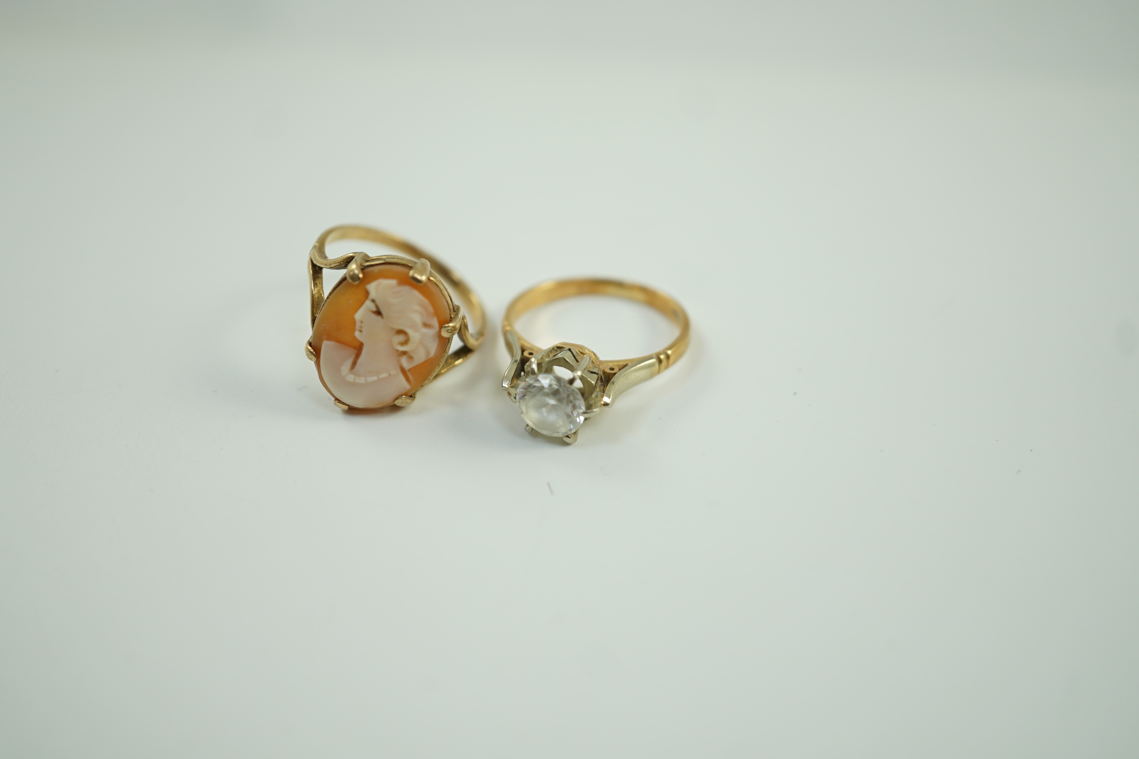 A 750 yellow metal and white zircon ring, gross 4 grams and a yellow metal and cameo shell ring, gross 2.8 grams.